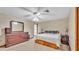 A carpeted main bedroom featuring a ceiling fan, closet and neutral colored walls at 6406 Butternut Dr, Lakeland, FL 33813
