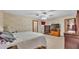 A carpeted main bedroom featuring a ceiling fan, closet and neutral colored walls at 6406 Butternut Dr, Lakeland, FL 33813