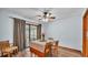 Bright dining area featuring hardwood flooring, a ceiling fan, and sliding glass doors to the outdoor patio at 6406 Butternut Dr, Lakeland, FL 33813