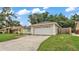 Charming single-story home featuring an attached two-car garage and a well-maintained front yard at 6406 Butternut Dr, Lakeland, FL 33813