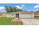 Charming single-story home featuring an attached two-car garage and a well-maintained front yard at 6406 Butternut Dr, Lakeland, FL 33813