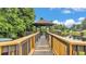 A view from a walkway to a covered gazebo sitting above a lake at 6406 Butternut Dr, Lakeland, FL 33813