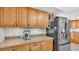 Bright kitchen with stainless steel appliances and wood cabinets offers functionality for culinary creations and storage at 6406 Butternut Dr, Lakeland, FL 33813