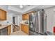 This light-filled kitchen features stainless appliances and wood cabinets, creating an inviting space for cooking and entertaining at 6406 Butternut Dr, Lakeland, FL 33813