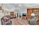 Spacious living room featuring vaulted ceilings, a brick fireplace, and hardwood floors at 6406 Butternut Dr, Lakeland, FL 33813