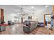 A expansive living room showcases vaulted ceilings, a brick fireplace, and hardwood floors at 6406 Butternut Dr, Lakeland, FL 33813