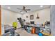 This office features a ceiling fan, neutral colored walls, and carpet at 6406 Butternut Dr, Lakeland, FL 33813
