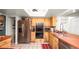 Traditional kitchen with stainless steel refrigerator, built in ovens, and wooden cabinets at 6421 Calusa Dr, Lakeland, FL 33813
