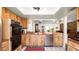 Classic kitchen with stainless steel appliances, wood cabinets, and views into living spaces at 6421 Calusa Dr, Lakeland, FL 33813