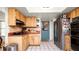 Functional kitchen featuring stainless steel refrigerator, wooden cabinets, and a tile backsplash at 6421 Calusa Dr, Lakeland, FL 33813