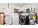 Functional laundry room equipped with a washer, dryer, and shelving for organized storage solutions at 6421 Calusa Dr, Lakeland, FL 33813