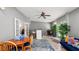 Bright living area featuring a ceiling fan, bar, seating area, and access to other rooms at 6421 Calusa Dr, Lakeland, FL 33813