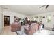 Spacious living room featuring neutral paint, tile floors, and a ceiling fan at 6421 Calusa Dr, Lakeland, FL 33813