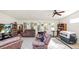 Spacious living room featuring neutral paint, tile floors, and a ceiling fan at 6421 Calusa Dr, Lakeland, FL 33813