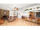 Open-concept living area with stone fireplace, kitchen bar, and dining space at 6421 Calusa Dr, Lakeland, FL 33813