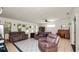 Spacious living room featuring neutral paint, tile floors, and a ceiling fan at 6421 Calusa Dr, Lakeland, FL 33813
