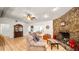Spacious living room with a stone fireplace, tile floors, and a ceiling fan at 6421 Calusa Dr, Lakeland, FL 33813