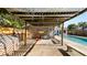 View of a backyard patio with a pergola, outdoor seating, and pool equipment at 6421 Calusa Dr, Lakeland, FL 33813
