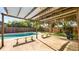 View of a covered pergola, patio, pool, and landscaping at 6421 Calusa Dr, Lakeland, FL 33813