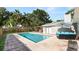 Outdoor view of a pool, patio furniture, wood fence, and lush greenery at 6421 Calusa Dr, Lakeland, FL 33813