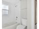 Bathroom featuring a tub and shower combo, white tile, and a toilet at 6707 Hillis Dr, Lakeland, FL 33813