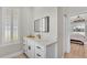 Bright bathroom with quartz countertops, shaker cabinets and modern fixtures at 6707 Hillis Dr, Lakeland, FL 33813
