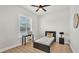 Bright bedroom features wood floors, a ceiling fan, and a window with lots of natural light at 6707 Hillis Dr, Lakeland, FL 33813