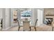 Bright breakfast nook with a fireplace, a view of the screened in lanai, and a glass top table at 6707 Hillis Dr, Lakeland, FL 33813