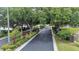 Community entrance featuring lush landscaping and a secure gate, enhancing the property's curb appeal and exclusivity at 6707 Hillis Dr, Lakeland, FL 33813