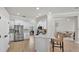 Bright open kitchen with stainless steel appliances, white cabinetry, and a view of the living room at 6707 Hillis Dr, Lakeland, FL 33813