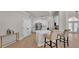 Kitchen with white cabinets, quartz countertops, stainless steel appliances, and a seating area at 6707 Hillis Dr, Lakeland, FL 33813