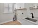 Modern laundry room with shaker cabinets, sink, and quartz counters at 6707 Hillis Dr, Lakeland, FL 33813