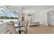 Cozy living room with a fireplace, dining nook, and an open view of the screened in lanai at 6707 Hillis Dr, Lakeland, FL 33813