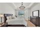 Bright main bedroom with light wood floors and sliding door to a screened pool at 6707 Hillis Dr, Lakeland, FL 33813