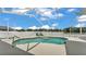 The inviting, screened-in pool boasts a unique shape and provides a perfect oasis for relaxation at 6707 Hillis Dr, Lakeland, FL 33813