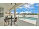 Pool and seating area covered by screened enclosure with a ceiling fan and a table with chairs at 6707 Hillis Dr, Lakeland, FL 33813