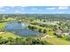 An aerial shot showcases a lakeside community with houses near golf courses and ponds, offering a picturesque and active lifestyle at 6964 Lake Eaglebrooke Dr, Lakeland, FL 33813