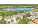 An aerial view of a beautiful home near a tranquil lake and lush golf course showcases luxury living in a serene environment at 6964 Lake Eaglebrooke Dr, Lakeland, FL 33813