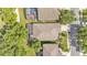 Aerial view of a home with a screened in porch and a landscaped backyard at 6964 Lake Eaglebrooke Dr, Lakeland, FL 33813