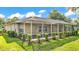 Spacious screened-in lanai surrounded by manicured hedges, offering an ideal space for outdoor relaxation at 6964 Lake Eaglebrooke Dr, Lakeland, FL 33813