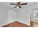 Bright bedroom featuring hardwood floors, a ceiling fan, neutral walls, and a spacious closet at 6964 Lake Eaglebrooke Dr, Lakeland, FL 33813