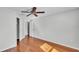 Bedroom with hardwood floors, ceiling fan, and closet at 6964 Lake Eaglebrooke Dr, Lakeland, FL 33813
