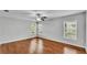 Bright bedroom with hardwood floors, a ceiling fan, and multiple windows at 6964 Lake Eaglebrooke Dr, Lakeland, FL 33813
