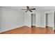 Bedroom with wood flooring, ceiling fan, and sliding door closet at 6964 Lake Eaglebrooke Dr, Lakeland, FL 33813