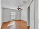 Bedroom featuring a ceiling fan, window and hardwood floors at 6964 Lake Eaglebrooke Dr, Lakeland, FL 33813