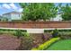Beautifully landscaped entrance to Eaglebrooke features brick wall and manicured garden beds at 6964 Lake Eaglebrooke Dr, Lakeland, FL 33813