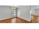 Well-lit dining area featuring hardwood floors, neutral walls, and an elegant chandelier at 6964 Lake Eaglebrooke Dr, Lakeland, FL 33813