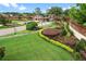 A landscaped entrance with manicured lawns and colorful flowerbeds enhances curb appeal and welcomes visitors to a premier community at 6964 Lake Eaglebrooke Dr, Lakeland, FL 33813