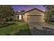 Charming home with a two-car garage, well-maintained lawn, and mature landscaping at 6964 Lake Eaglebrooke Dr, Lakeland, FL 33813