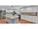 Bright kitchen with stainless steel appliances, custom backsplash, and large center island at 6964 Lake Eaglebrooke Dr, Lakeland, FL 33813